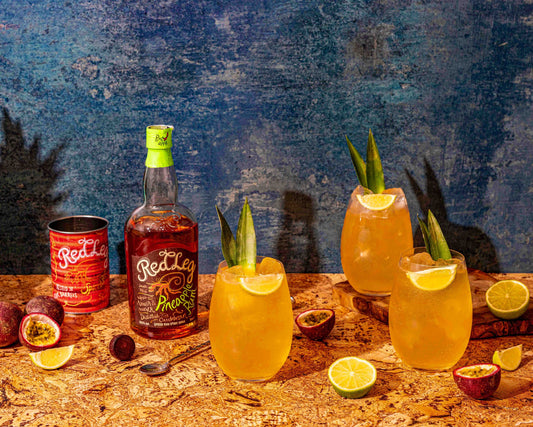 RedLeg Pineapple Rum with 3 glasses filled with Caribbean spritz cocktail