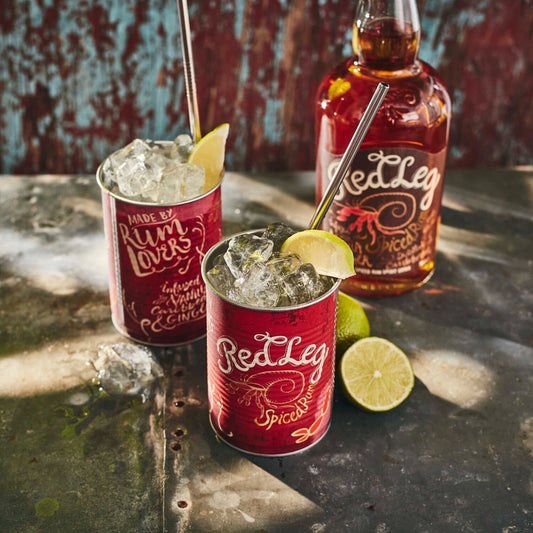 Bottle of RedLeg rum with two tins filled with cocktails